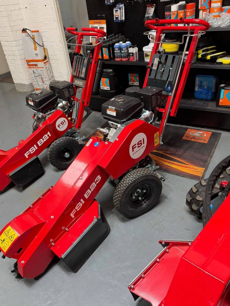 New FSI B21 and B23 stump grinders in front of the stocked parts wall in the Sky-Arb workshop
